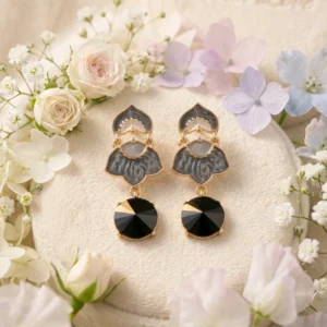 Obsidian Petal Danglers: Black Vintage Drop Earrings with gold-tone accents and grey enamel floral motifs.