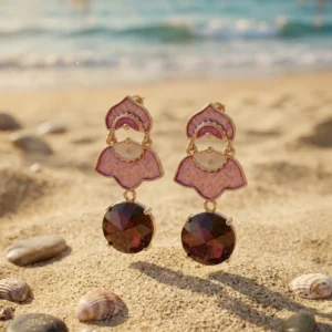 Velvet Petal Danglers pink floral earrings with red gemstone drops placed on natural forest background